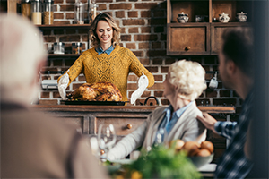 Woman serving a Turkey for Thanksgiving